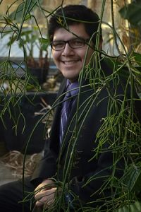 Carlos Rivera '15, pictured here in the greenhouse of Regents Hall of Natural and Mathematical Sciences, and Mohamed Haji '13 traveled to Washington, D.C., this week to present at the Emerging Researchers National Conference.