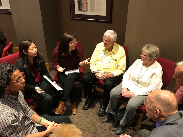 St. Olaf students in dialogue with older adults in small group discussion.