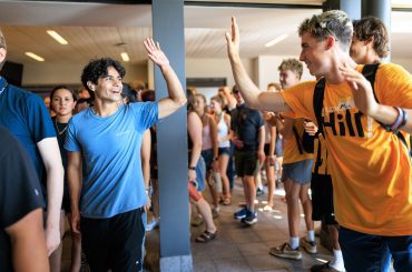 First-year students get a welcome high-five from Oles leading orientation activities.