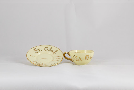 A miniature St. Olaf College teacup and saucer from the Archives’ 3D Object Collection.