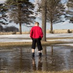 Person standing in pond.