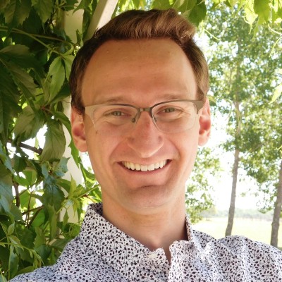 Image of man in front of a trees.