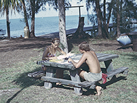 two students studying on beach