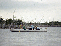 students and prof in canoe