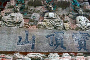 Statues and Chinese writing on hillside