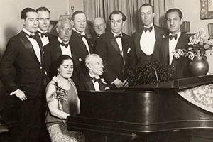 Maurice Ravel at piano with group of people