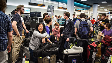 St. Olaf students with instruments at airport while traveling to Cuba