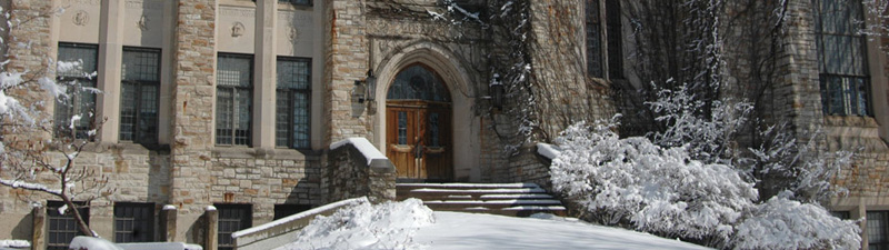 A view of the front entrance of Rolvaag Library in the snow.