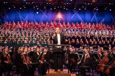 Dr. Anton Armstrong conducts the Massed Choirs and St. Olaf Orchestra during the 2019 Christmas Festival