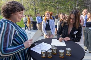 Students signing their name in the Phi Beta Kappa book