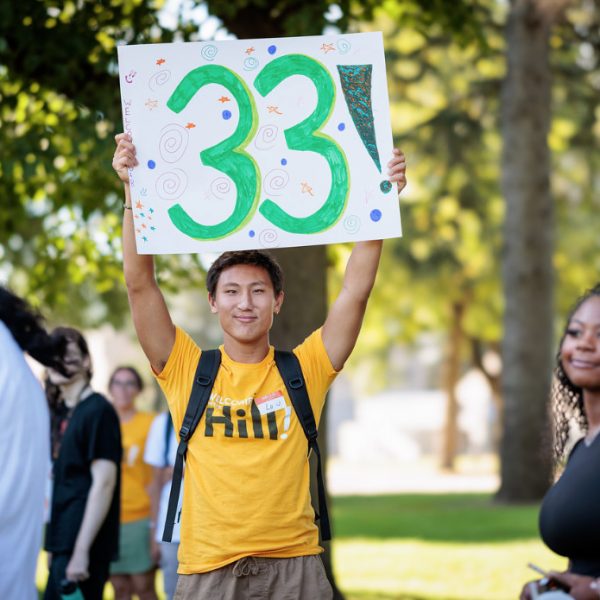 A SOAR leader welcoming their group with a sign