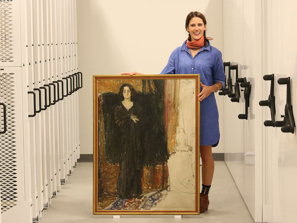 Jane Becker Nelson holding "Eva," an unfinished painting that will undergo scientific testing.